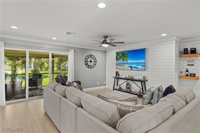 tiled living room with wood walls, ceiling fan, and ornamental molding