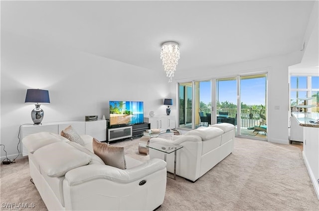 living room with a notable chandelier and light colored carpet