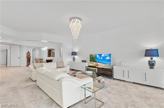 living room featuring a chandelier and light colored carpet