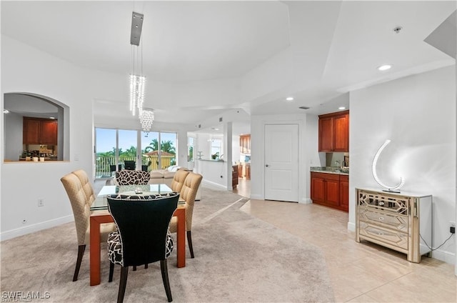 dining space featuring an inviting chandelier and light tile patterned flooring