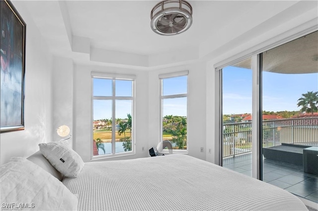 bedroom with a water view and access to outside