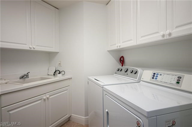 laundry area with cabinets, sink, and washing machine and dryer