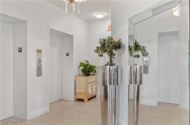 corridor featuring light tile patterned flooring and elevator