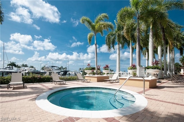 view of pool featuring a hot tub and a patio area