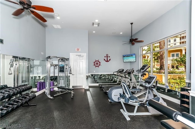 workout area with a high ceiling and ceiling fan