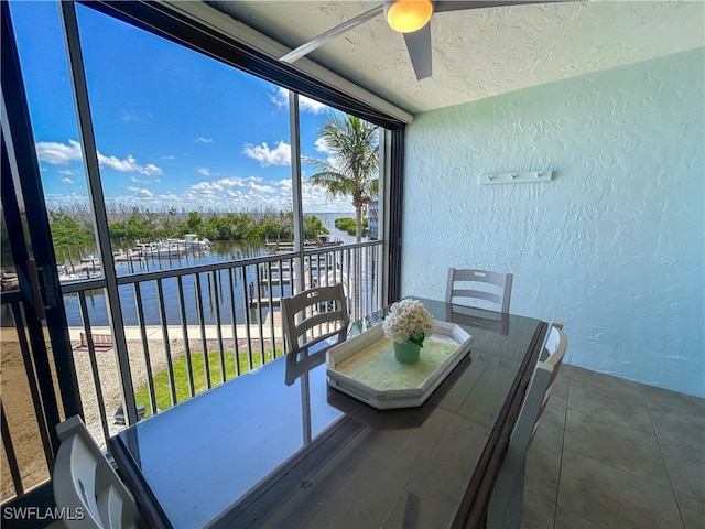 exterior space featuring a water view and ceiling fan