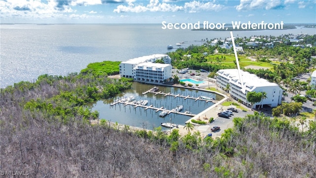 birds eye view of property with a water view