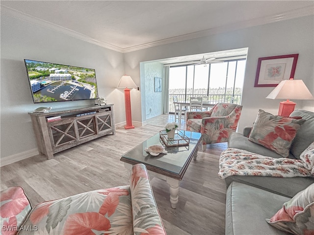 living room with wood-type flooring and ornamental molding