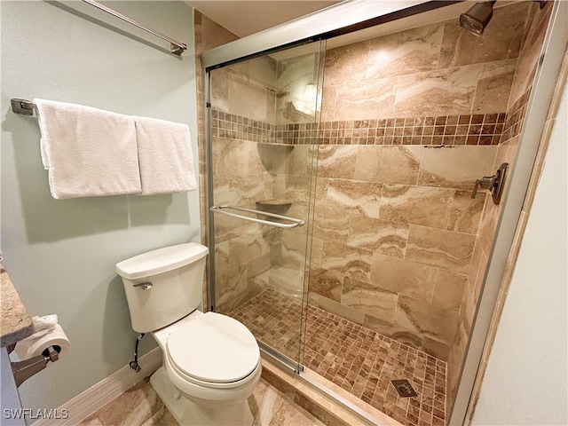 bathroom with toilet and a shower with door