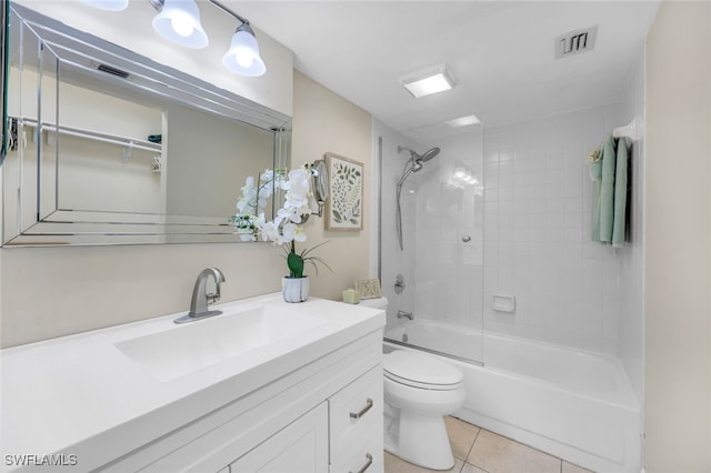 full bathroom featuring tile patterned flooring, vanity, toilet, and tiled shower / bath combo