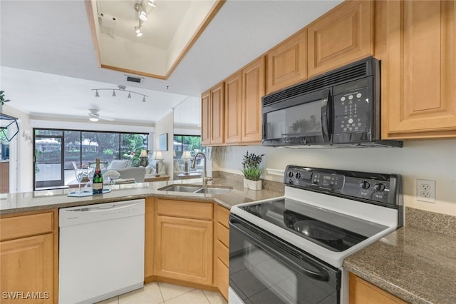 kitchen featuring light tile patterned floors, dishwasher, electric range, sink, and dark stone counters