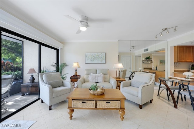 living room with ornamental molding, light tile patterned floors, and ceiling fan