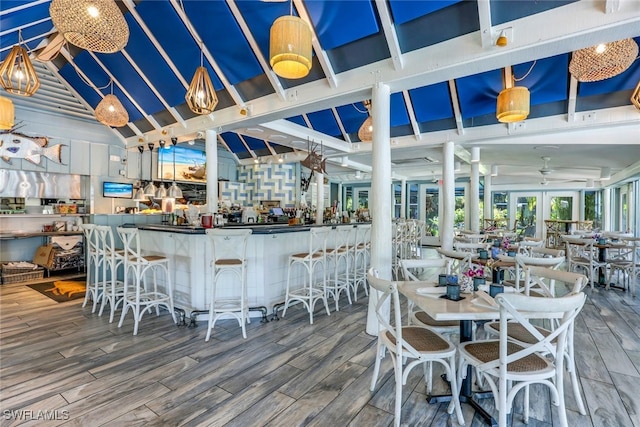 deck featuring ceiling fan and exterior bar