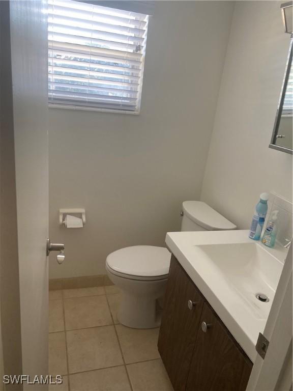 bathroom with tile patterned floors, toilet, and vanity