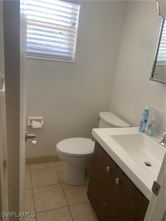 bathroom featuring vanity, toilet, and tile patterned flooring