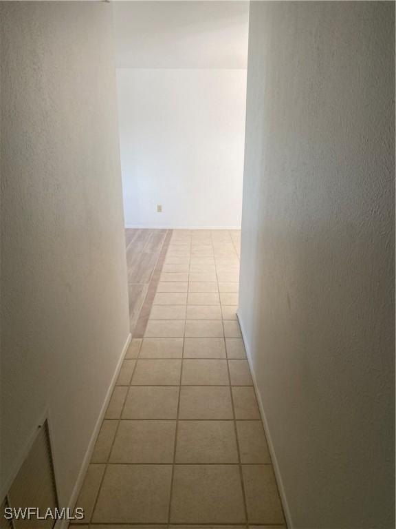 hallway with light tile patterned floors