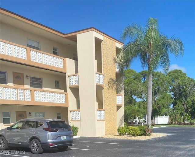 view of property featuring uncovered parking