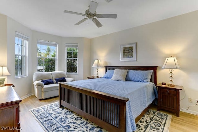 bedroom with light hardwood / wood-style flooring and ceiling fan