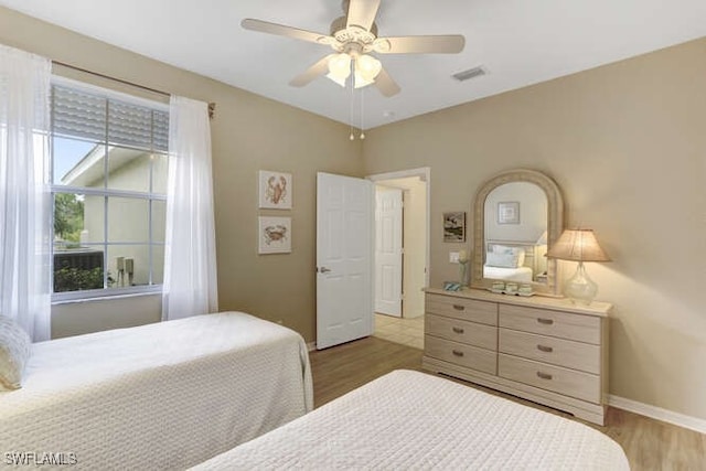 bedroom with ceiling fan and light hardwood / wood-style flooring