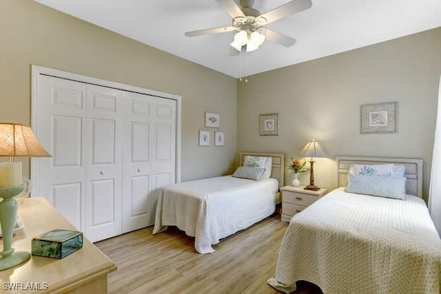 bedroom with a closet, ceiling fan, and light hardwood / wood-style floors