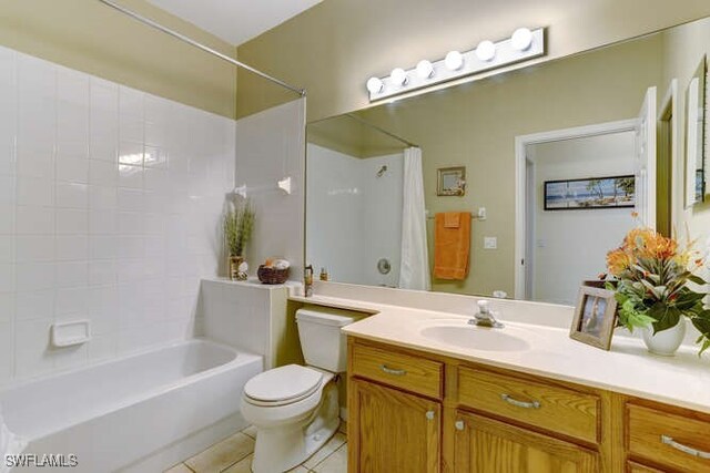 full bathroom featuring tile patterned flooring, vanity, toilet, and tiled shower / bath combo