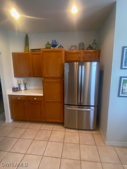 kitchen with stainless steel fridge and light tile patterned floors