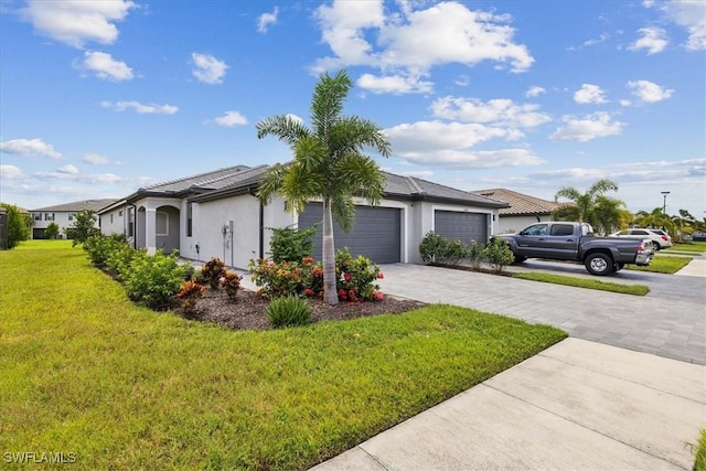 view of front of property with decorative driveway, an attached garage, a front lawn, and stucco siding