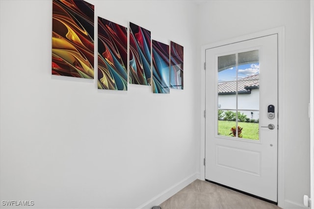 entryway featuring a wealth of natural light and light colored carpet