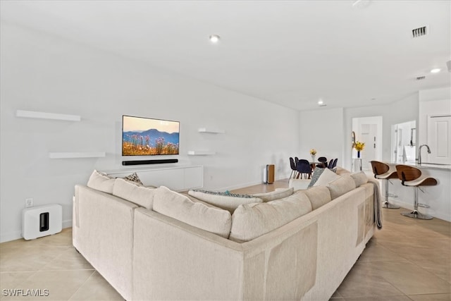 living room featuring light tile patterned floors and sink