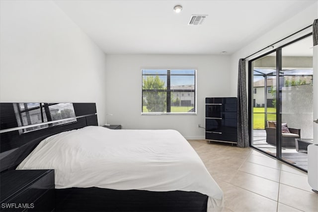 bedroom with access to outside and light tile patterned floors