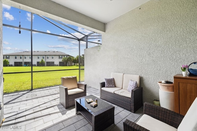 view of patio / terrace with an outdoor living space and glass enclosure