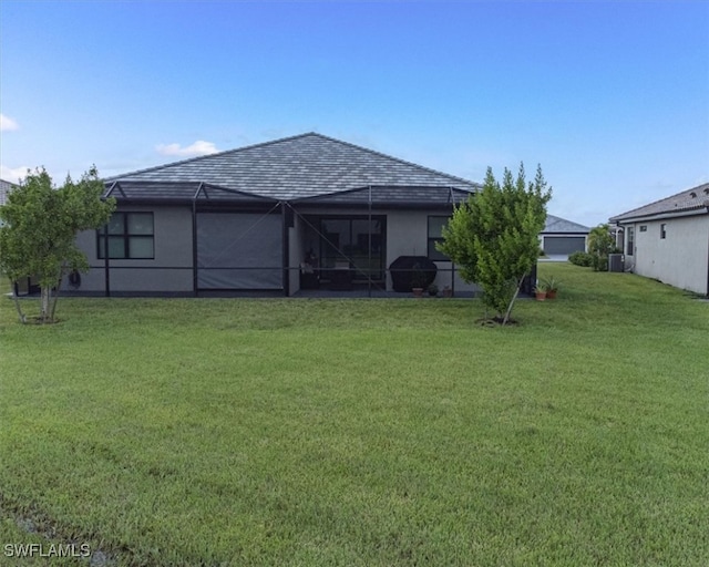 back of house with a lawn