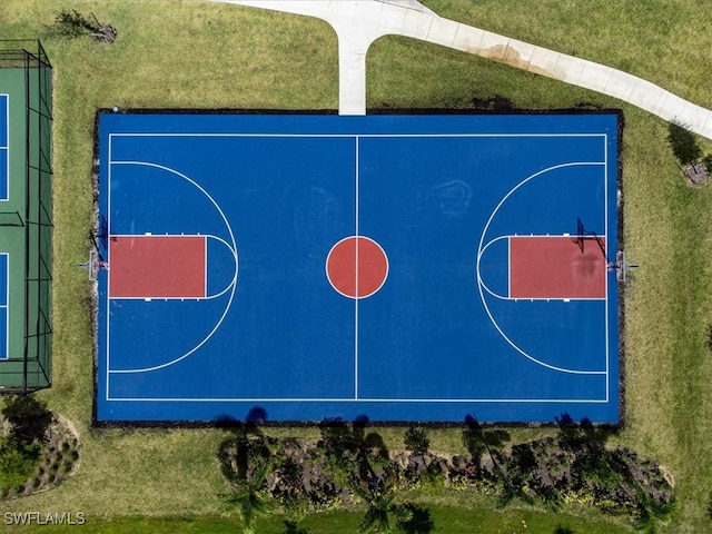 view of basketball court featuring a lawn