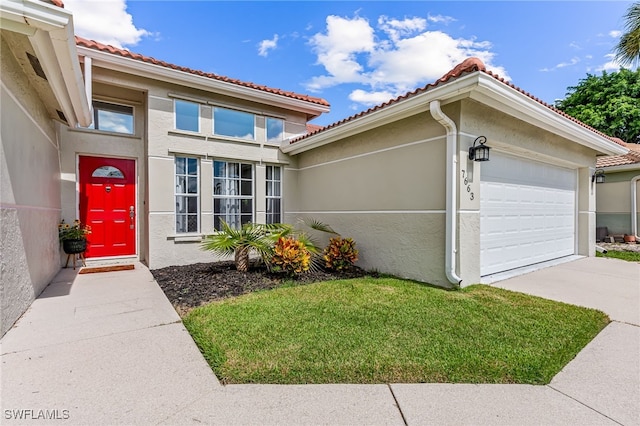 doorway to property with a garage