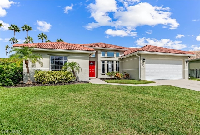 mediterranean / spanish-style home with a front yard and a garage