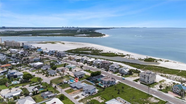 drone / aerial view featuring a water view and a view of the beach