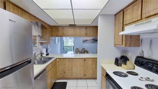 kitchen with sink, light tile patterned floors, and stainless steel appliances