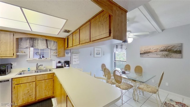 kitchen featuring ceiling fan, light tile patterned floors, beam ceiling, sink, and appliances with stainless steel finishes