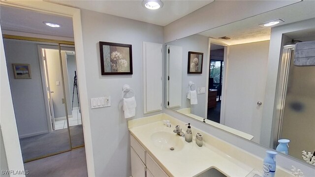 bathroom featuring an enclosed shower and vanity