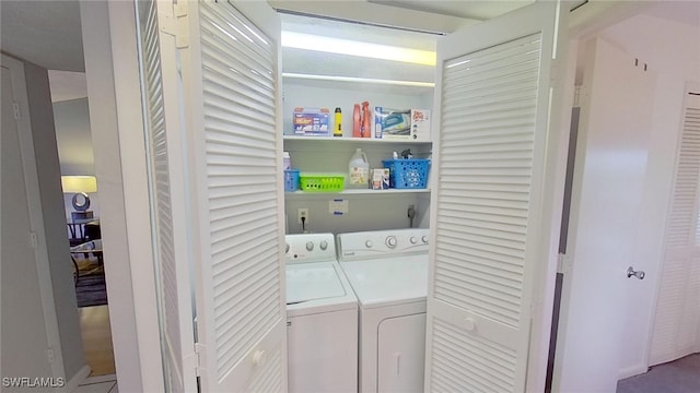 washroom with washing machine and clothes dryer