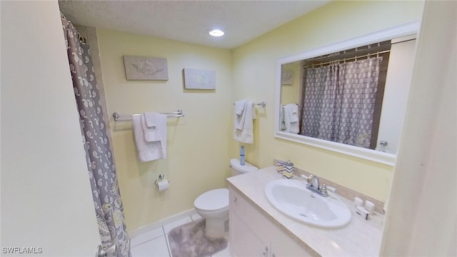 bathroom with vanity, tile patterned flooring, toilet, and a textured ceiling