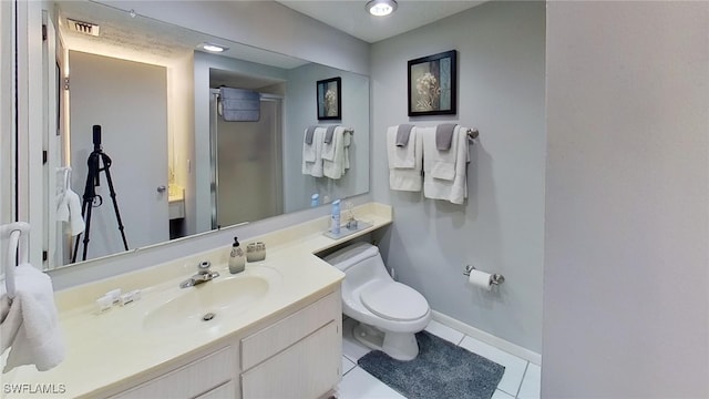 bathroom with walk in shower, vanity, toilet, and tile patterned floors