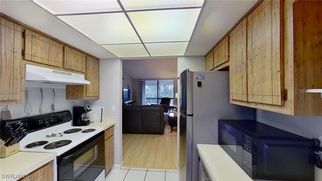 kitchen featuring light tile patterned floors and white electric stove