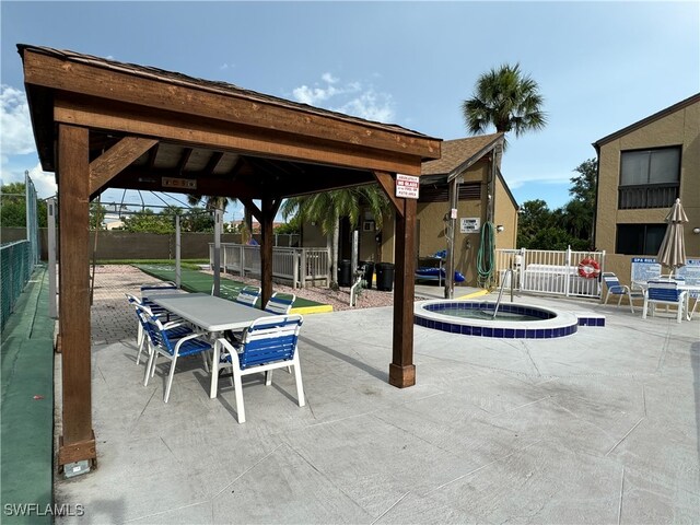 exterior space with a patio, a gazebo, and a hot tub