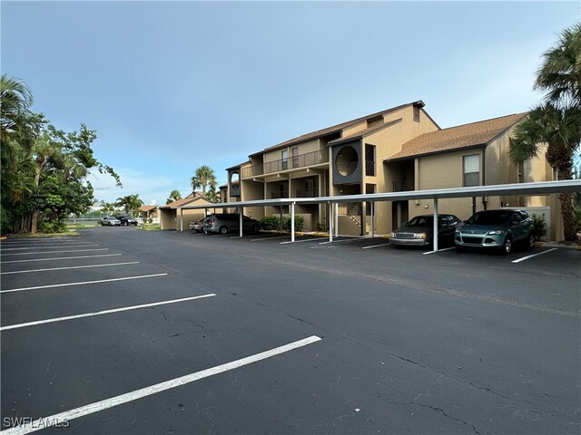 view of parking / parking lot featuring a carport