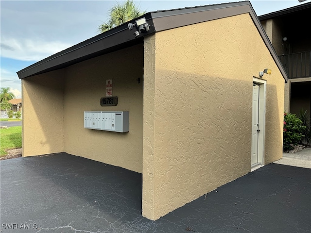 view of side of property with a mail area