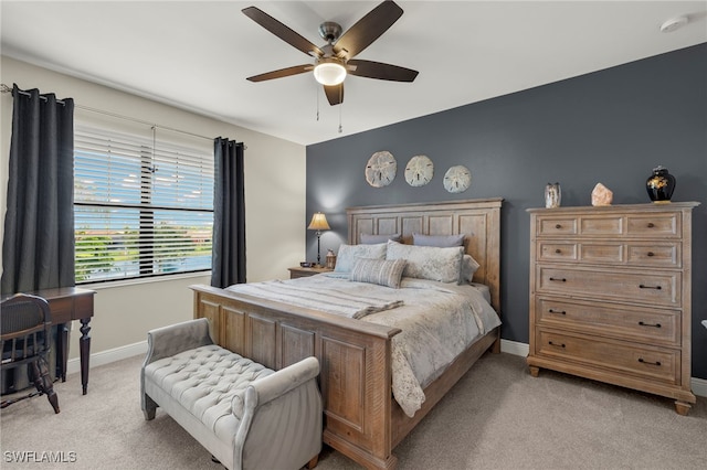 bedroom with light carpet, a ceiling fan, and baseboards