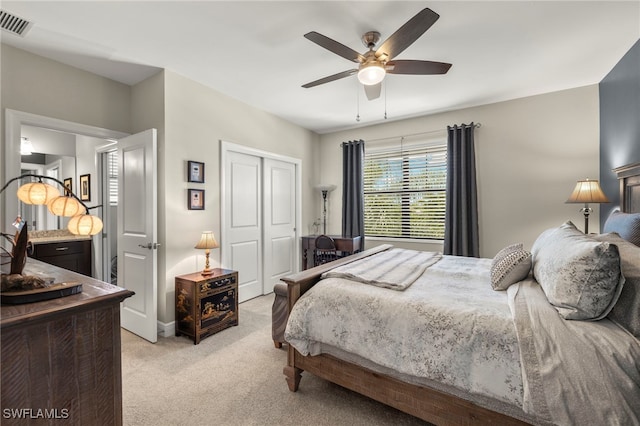 bedroom with light carpet, visible vents, ceiling fan, and a closet