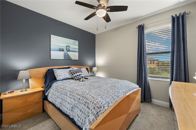 bedroom featuring baseboards, light carpet, and a ceiling fan