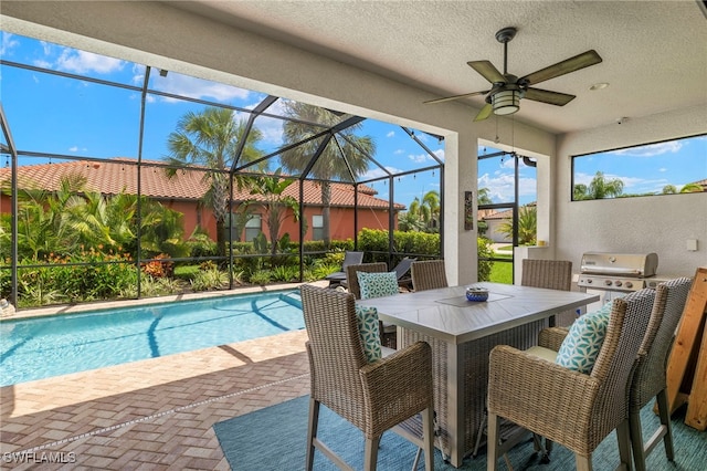 pool with outdoor dining space, a patio, glass enclosure, grilling area, and ceiling fan